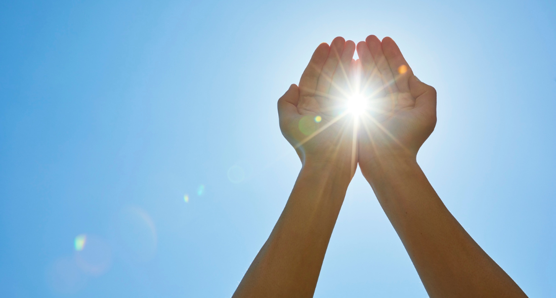 guide to sun safety, showing a UPF 55+ Handy Beach Umbrella protecting a family.