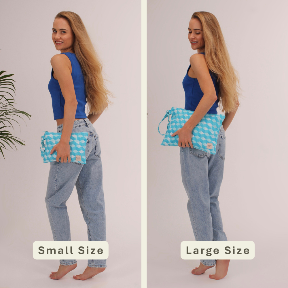 Woman modeling the Sea Mosaique Handy Beach Goods wristlet bag for scale and size comparison.
