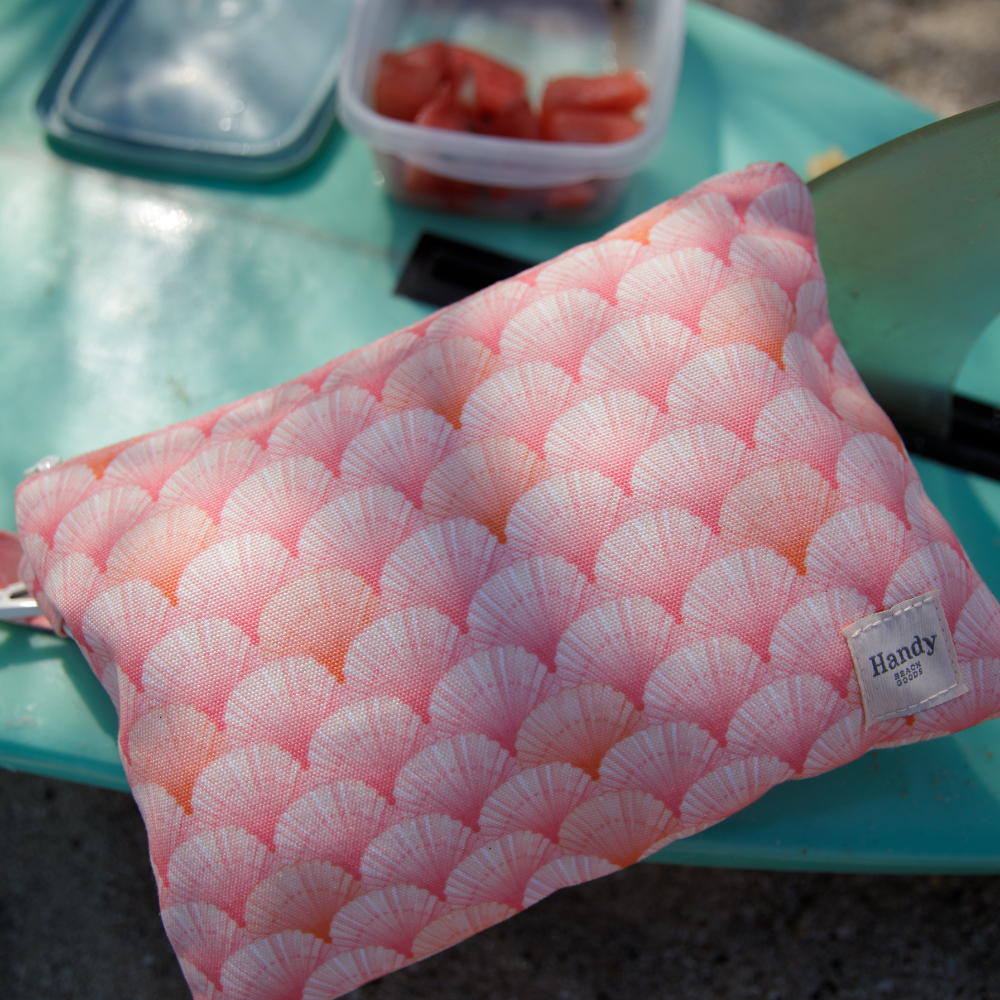 The Peach Shells beach wristlet bag by Handy Beach Goods in lifestyle setting. 
