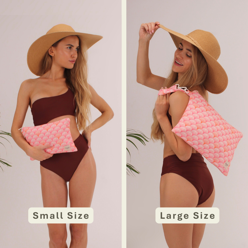 Woman modeling the Peach Shells Handy Beach Goods wristlet bag for scale and size comparison.