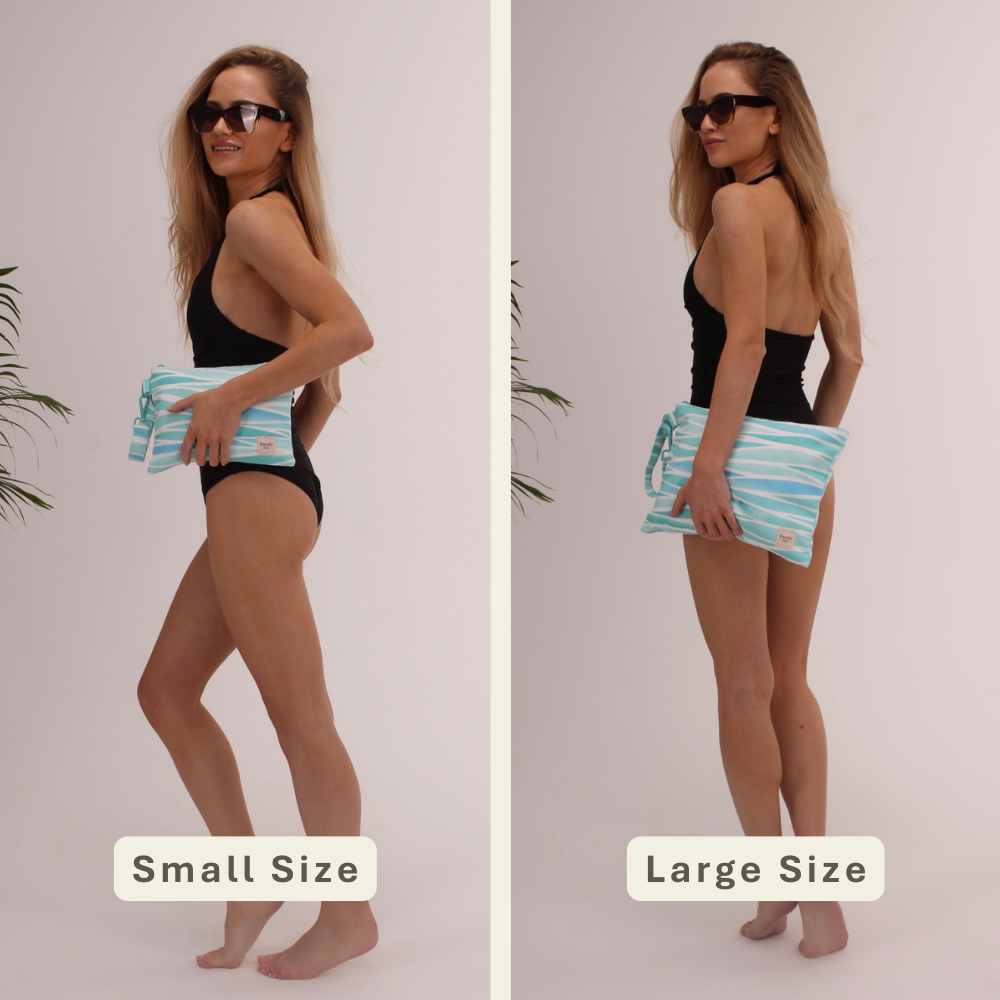 Woman modeling the Seascape Handy Beach Goods wristlet bag for scale and size comparison.