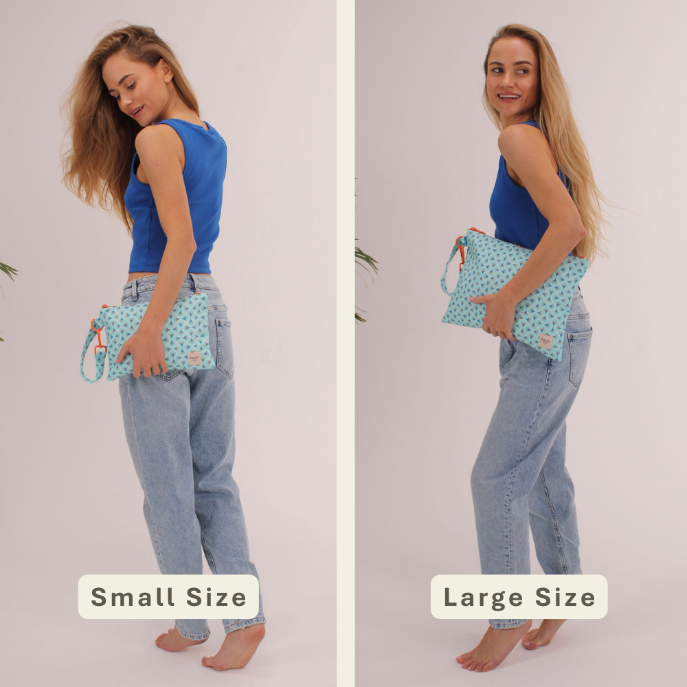 Woman modeling the Blue Prism Handy Beach Goods wristlet bag for scale and size comparison.