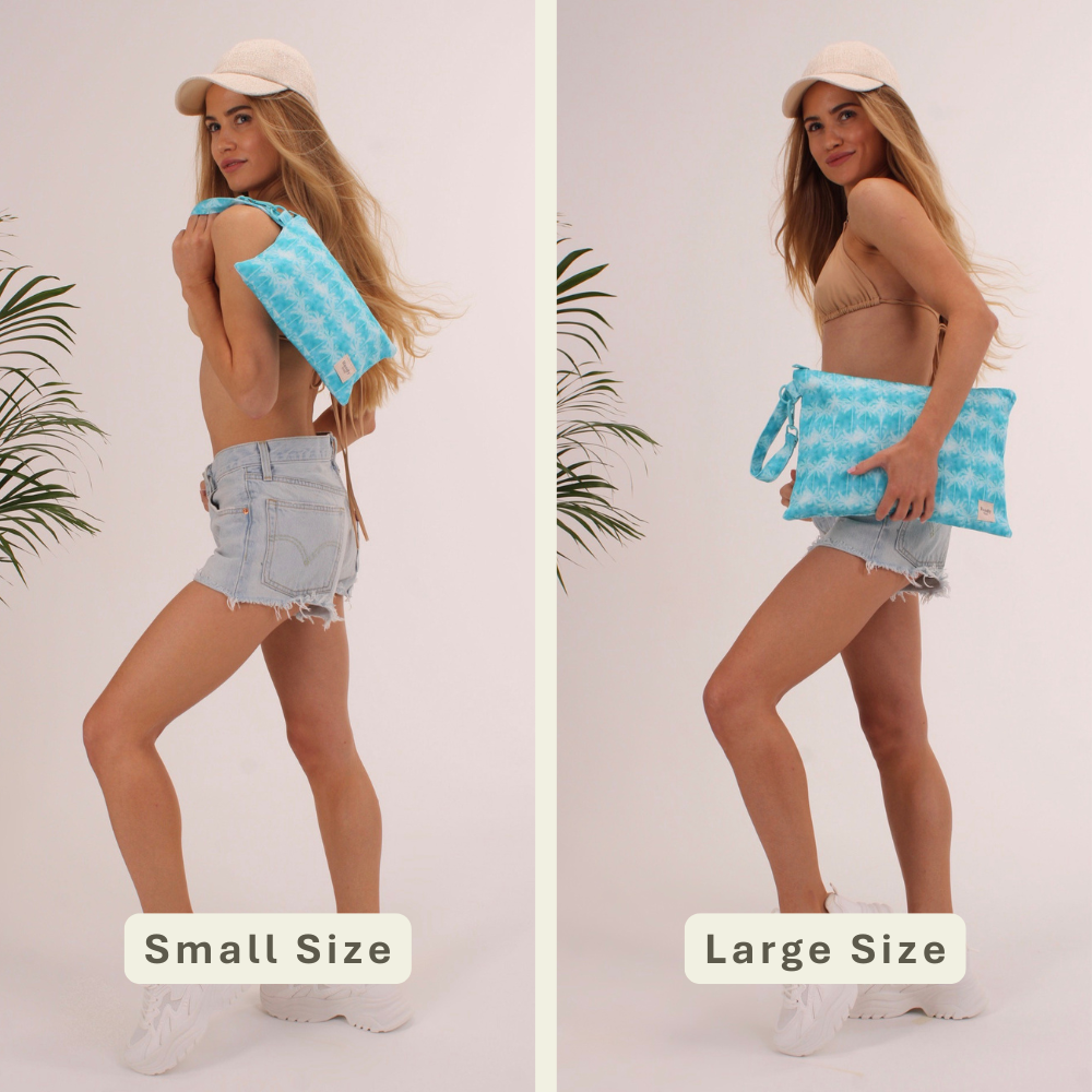 Woman modeling the Aqua Palms Handy Beach Goods wristlet bag for scale and size comparison.