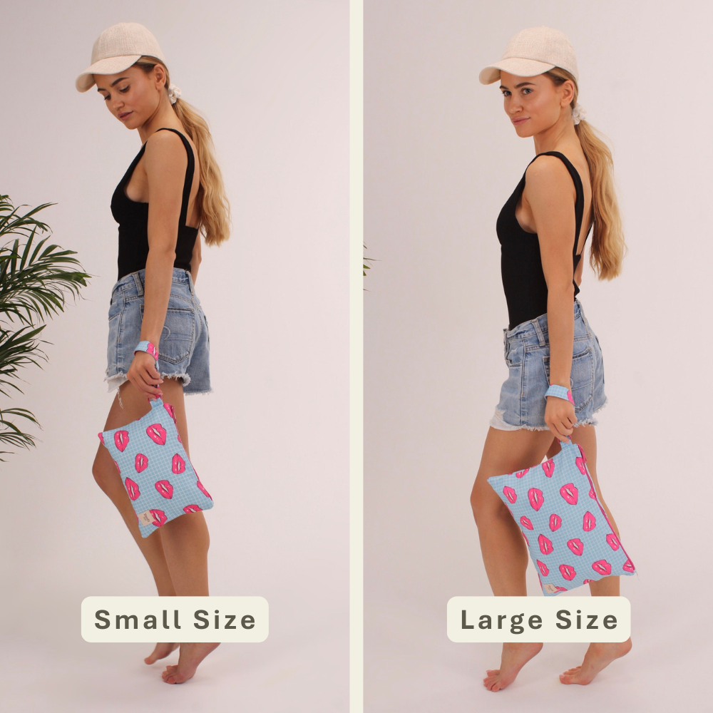 Woman modeling the Lips Handy Beach Goods wristlet bag for scale and size comparison.