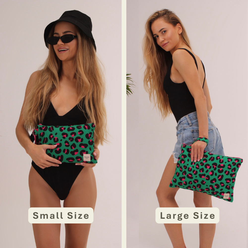 Woman modeling the Leopard Handy Beach Goods wristlet bag for scale and size comparison.
