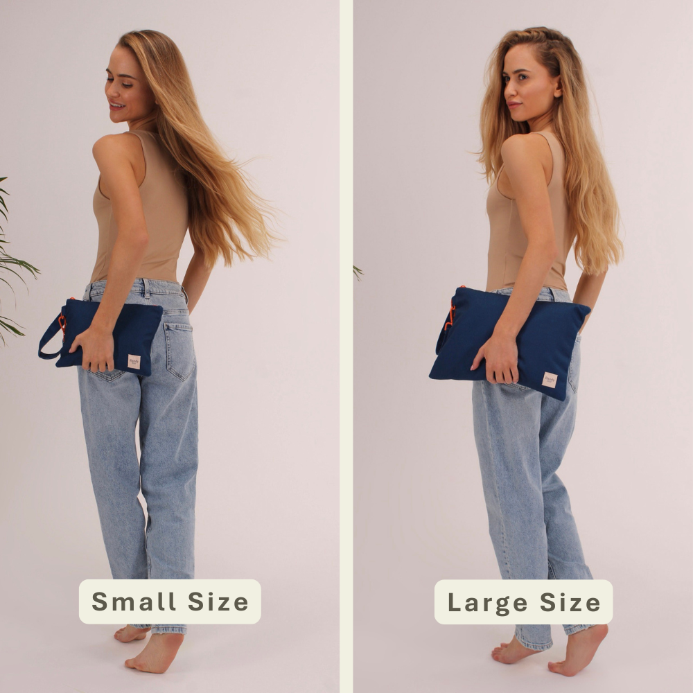 Woman modeling the Handy Blue Handy Beach Goods wristlet bag for scale and size comparison.
