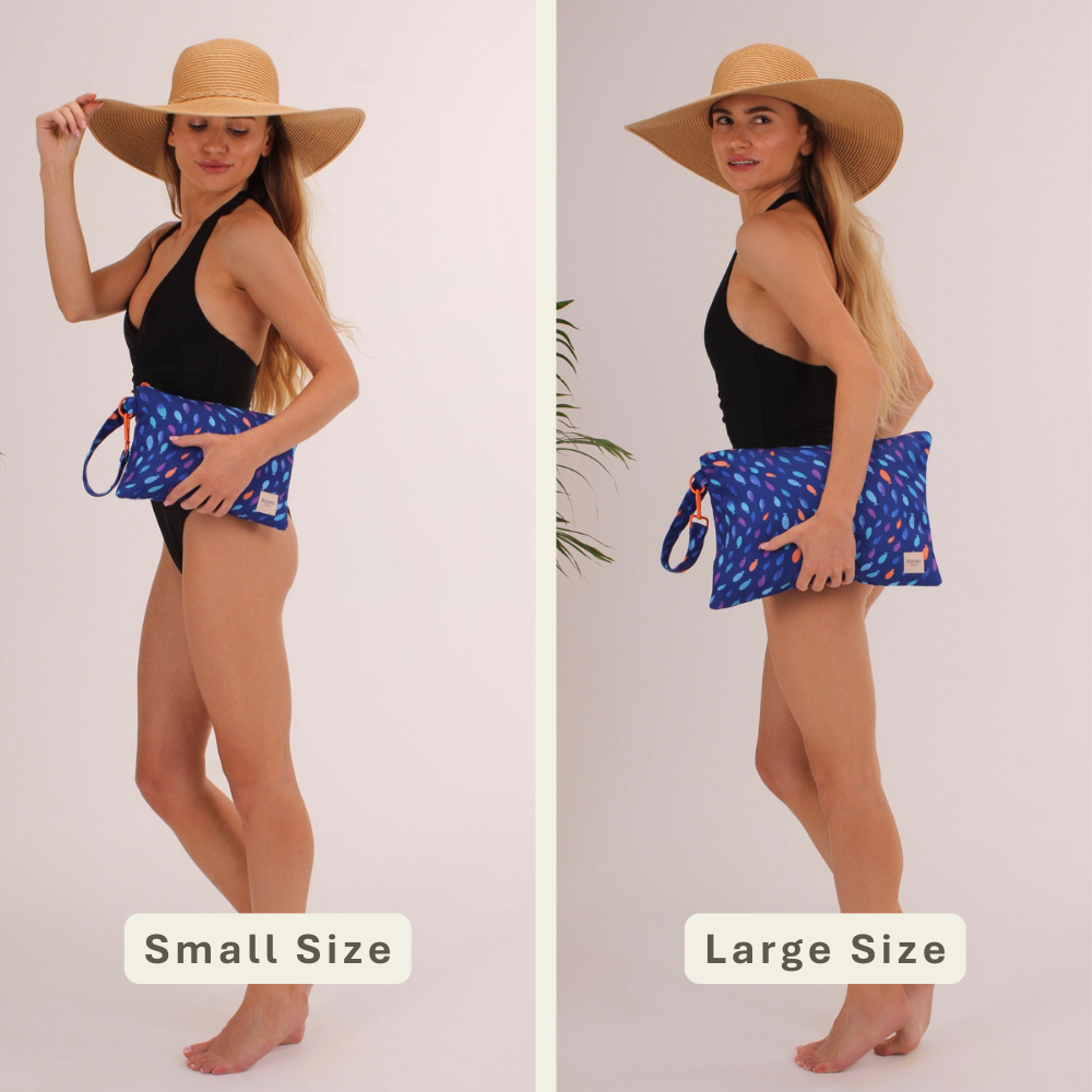 Woman modeling the Fish Handy Beach Goods wristlet bag for scale and size comparison.