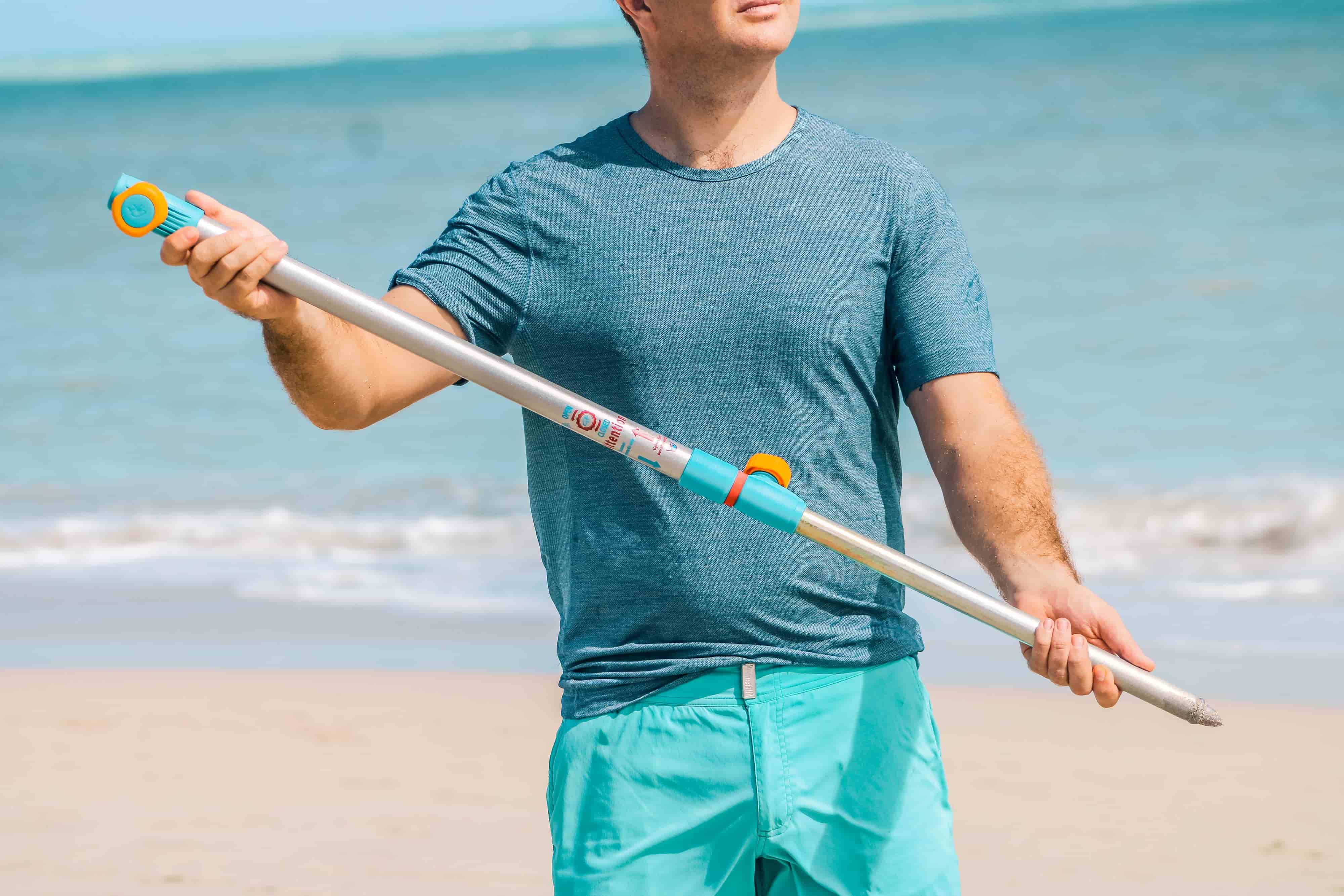 Person holding the Handy Beach Anchor that secures beach umbrellas