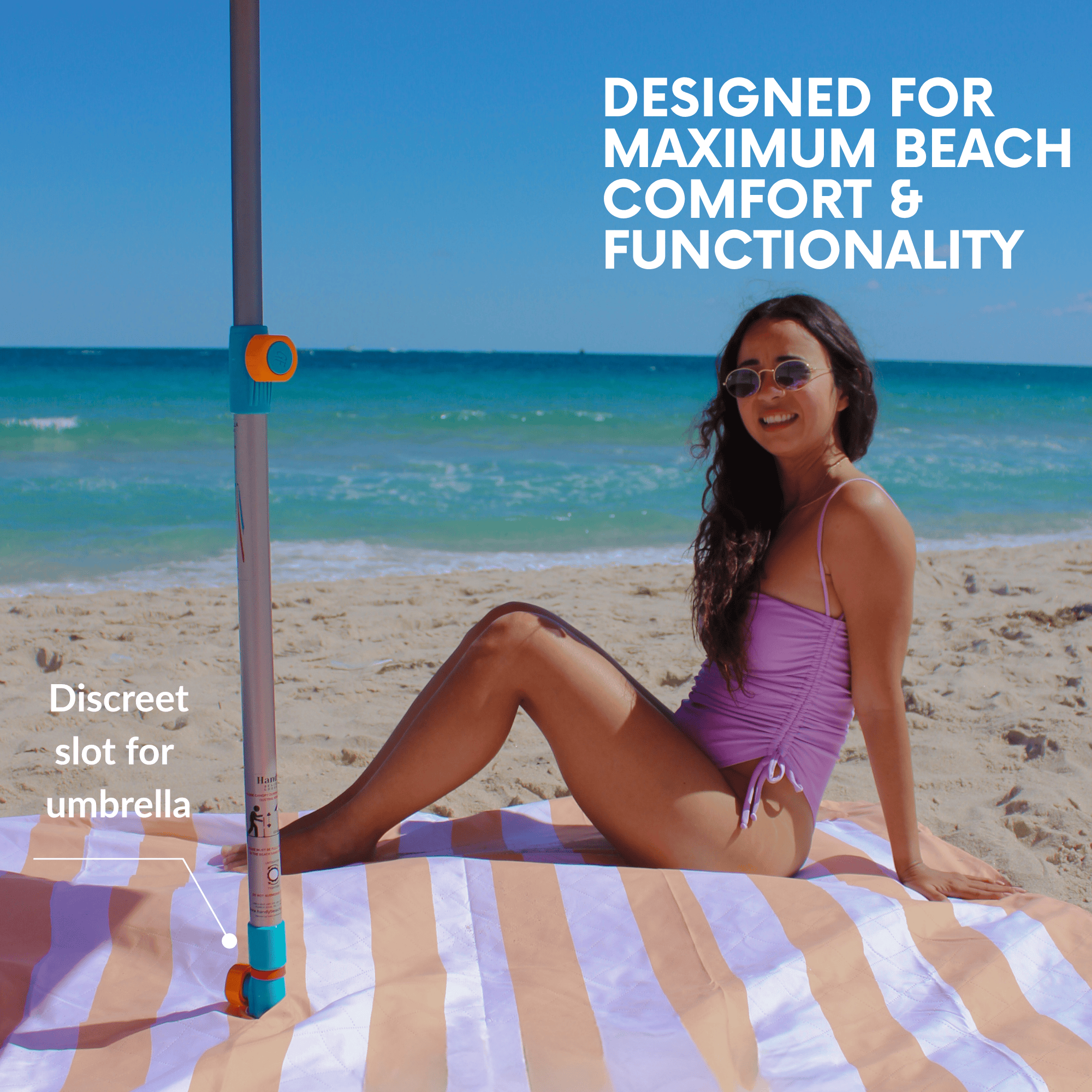 Woman sitting on a beach banket with an umbrella hole 