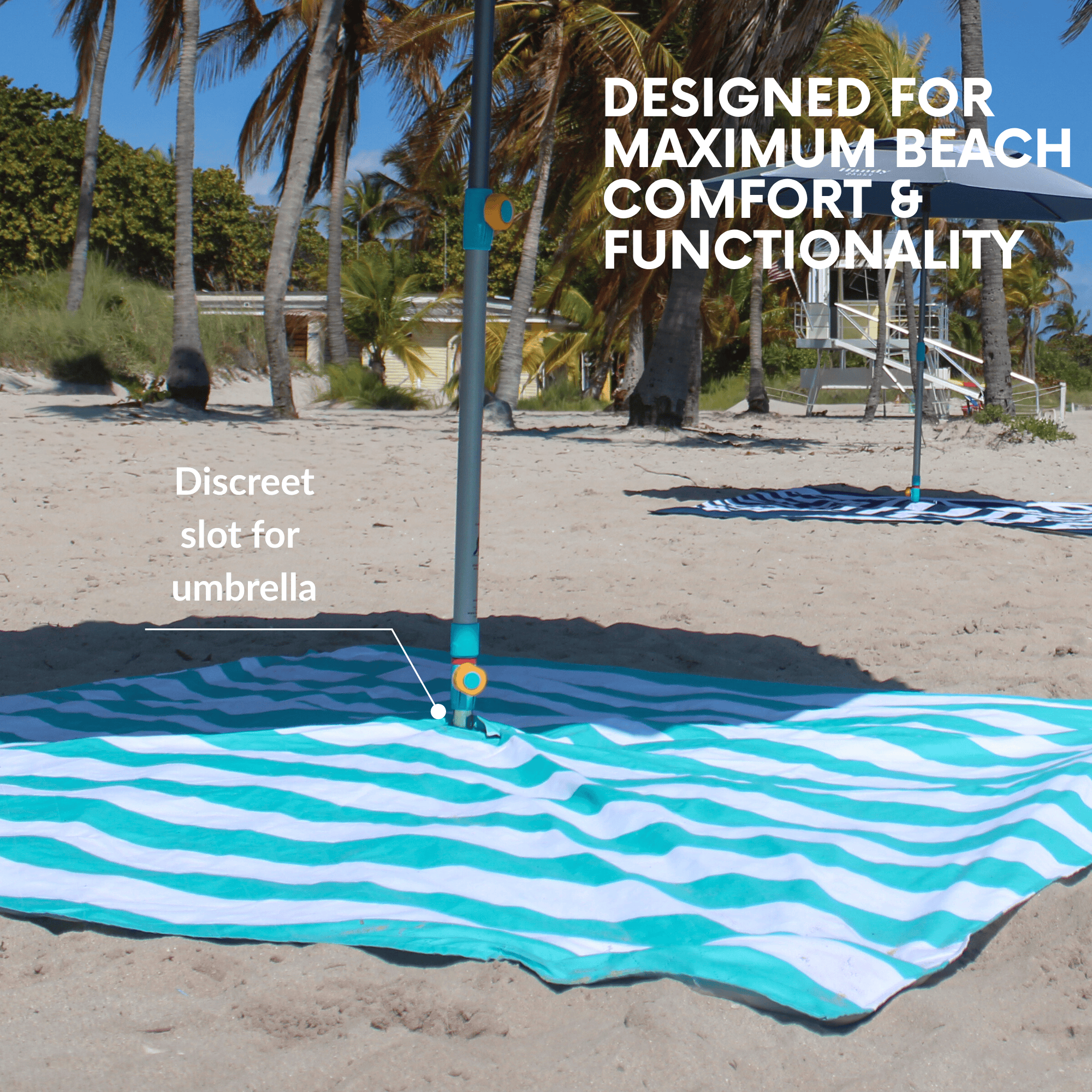 Teal striped beach blanket with a built-in center umbrella hole for seamless shade.