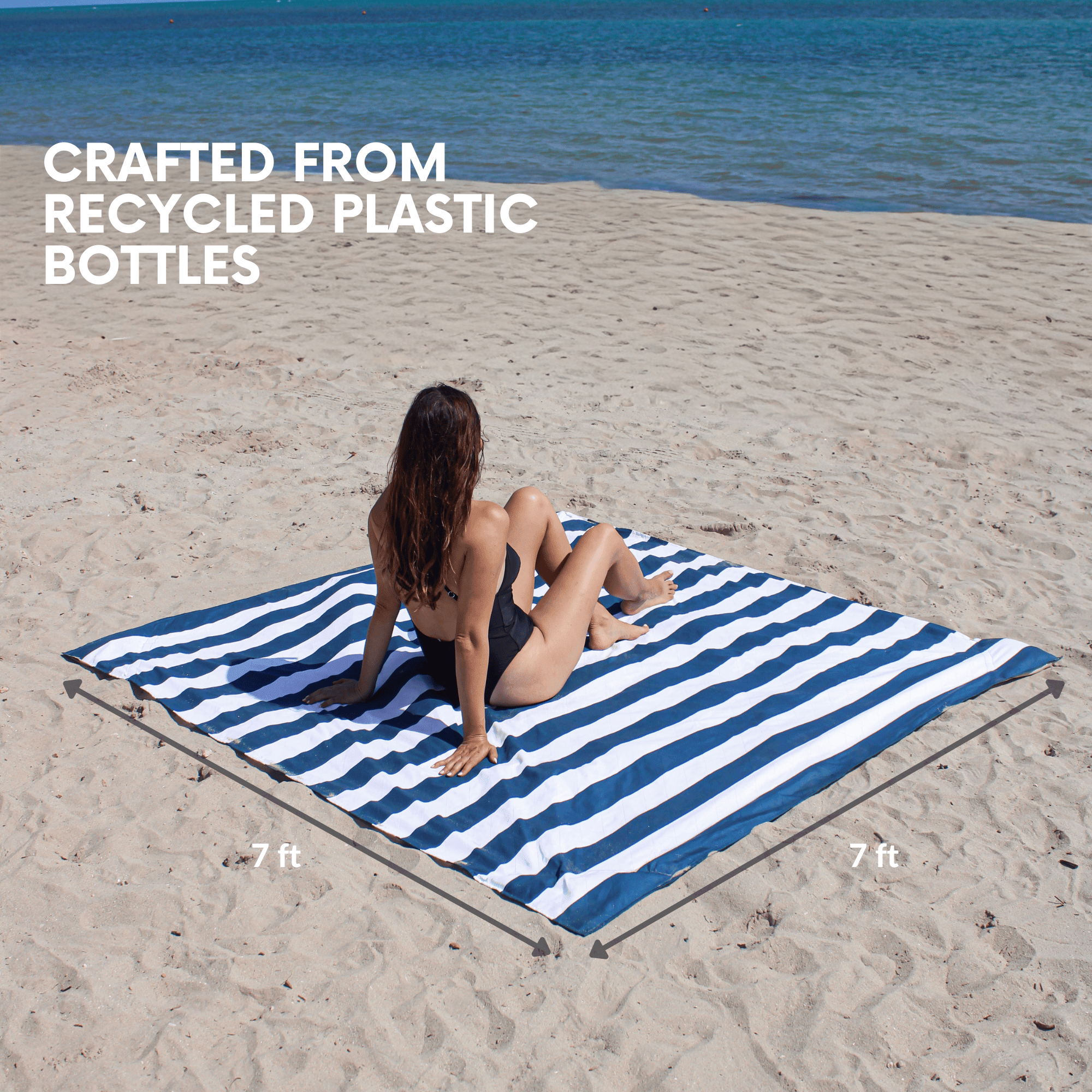 Woman sitting on an oversized 7x7 ft beach blanket crafted from recycled materials, providing plenty of space.