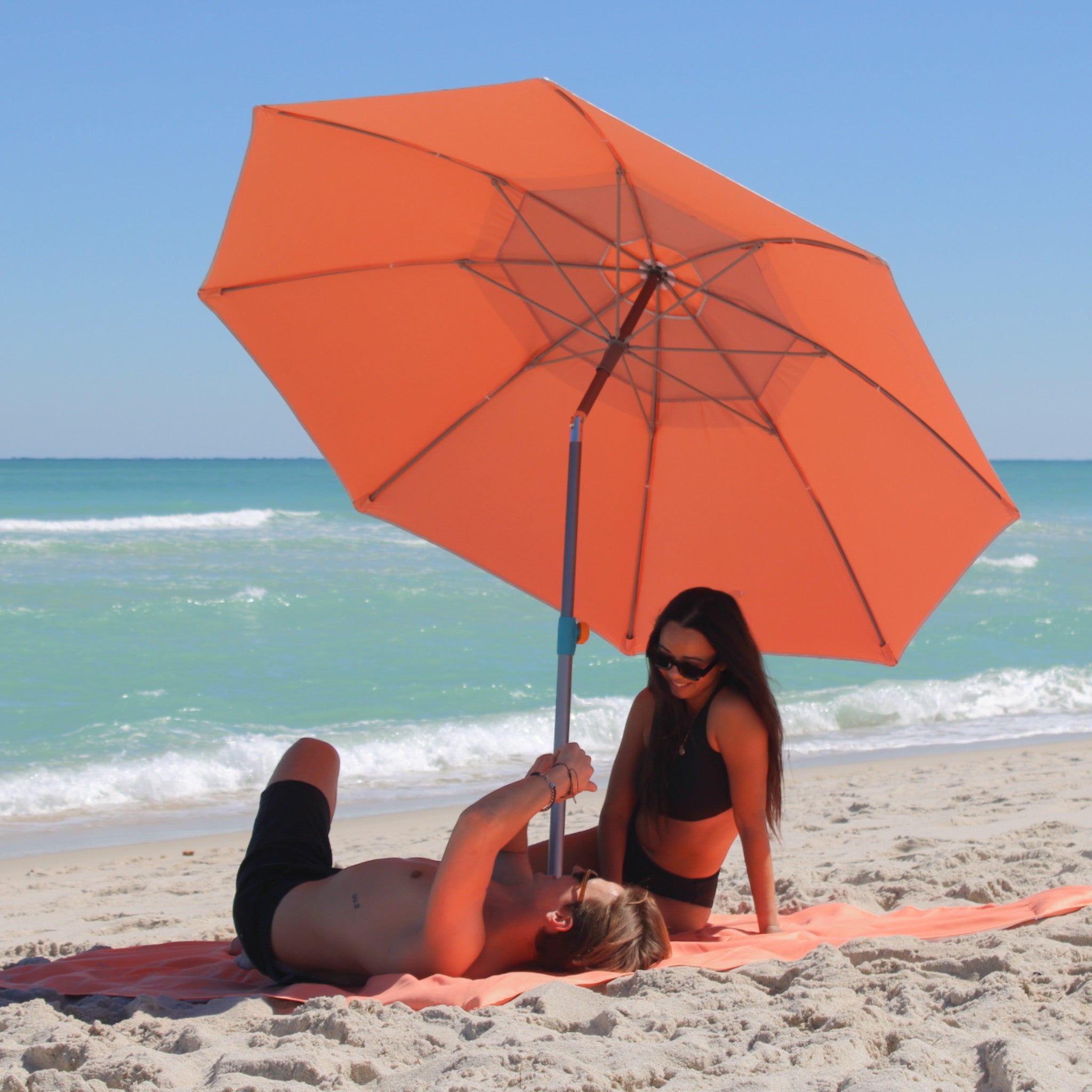 Couple enjoying beach shade under Handy Beach canopy