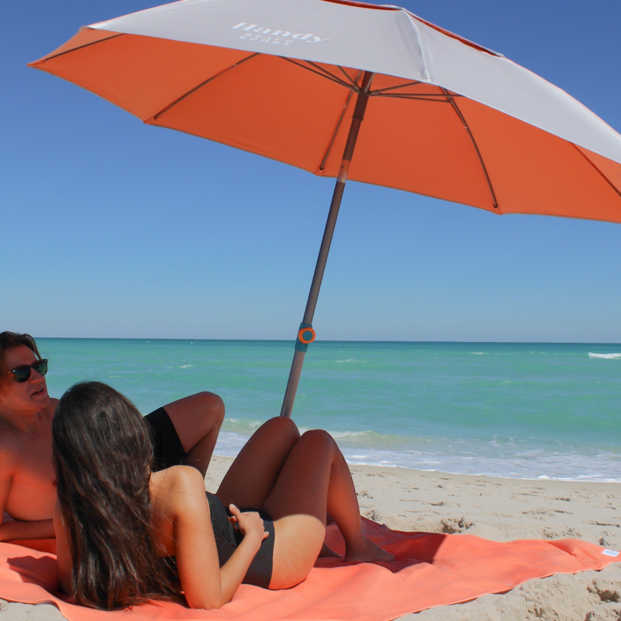 Couple enjoying the shade under the Handy Beach Umbrella & Anchor System